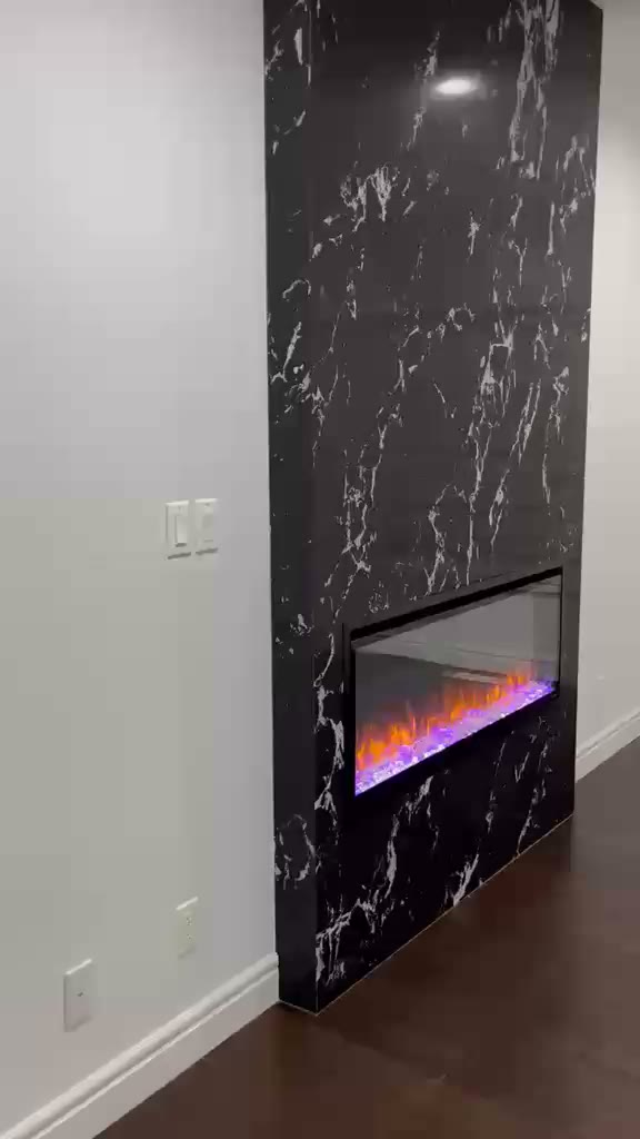 Video tour of a black marble fireplace and adjoining kitchen