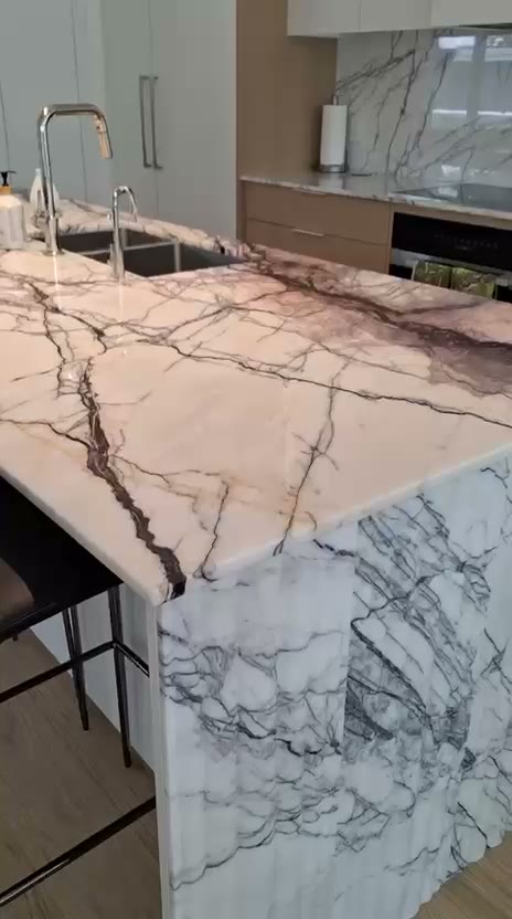 Video walkthrough of a kitchen with a marble-look quartz island
