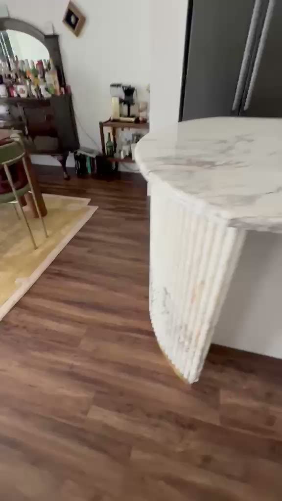 Video detail of a rounded marble-look quartz island leg fabrication