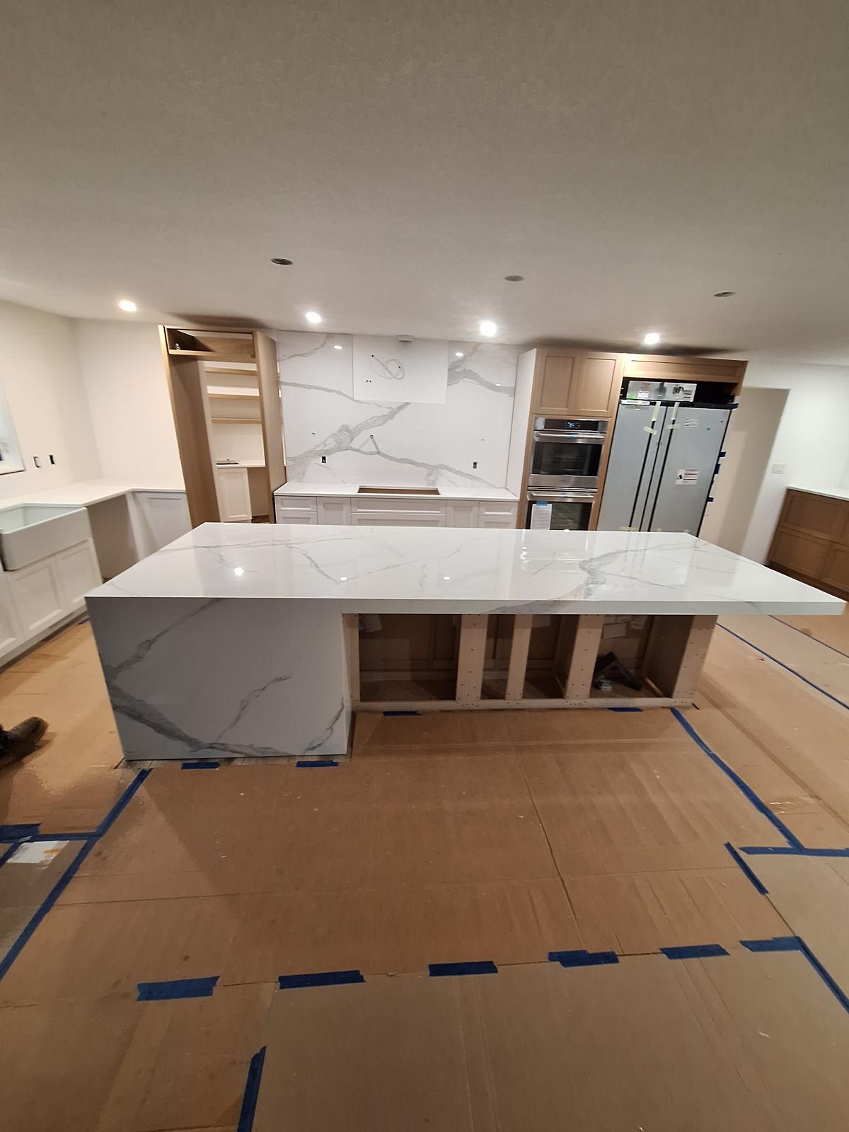 Angled view of a white quartz kitchen island