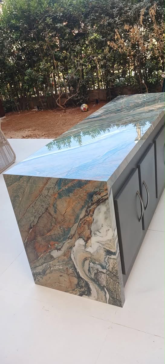 Angled view of a waterfall-edge porcelain BBQ island