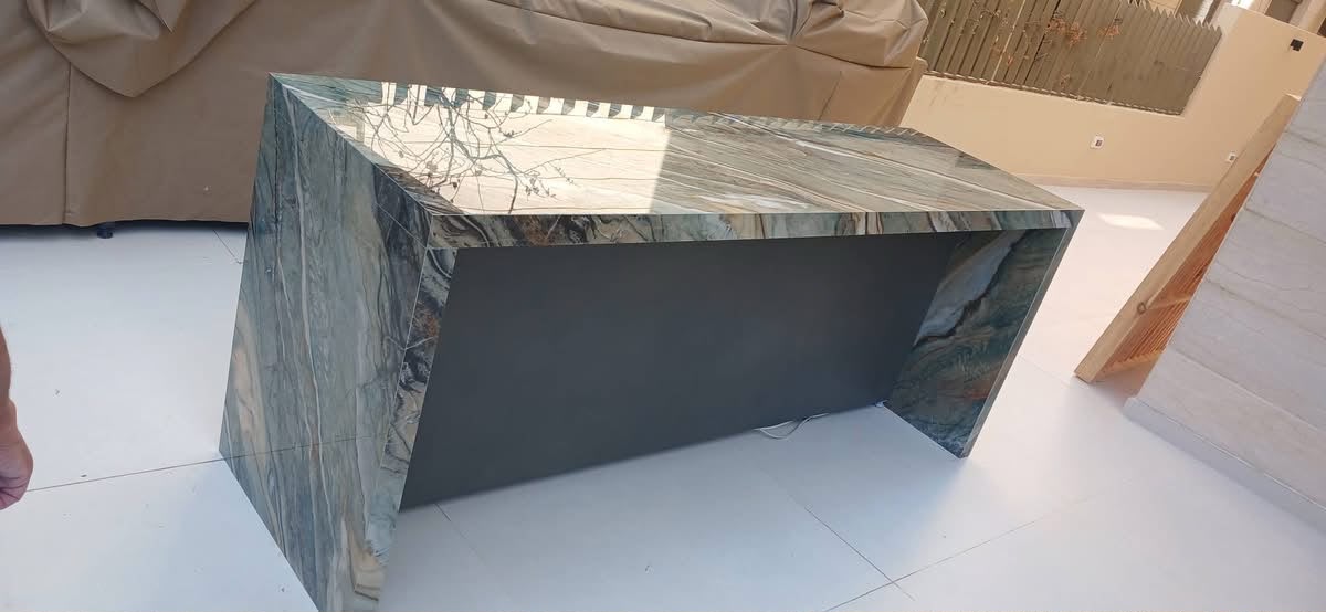 Side view of a waterfall-edge porcelain BBQ island