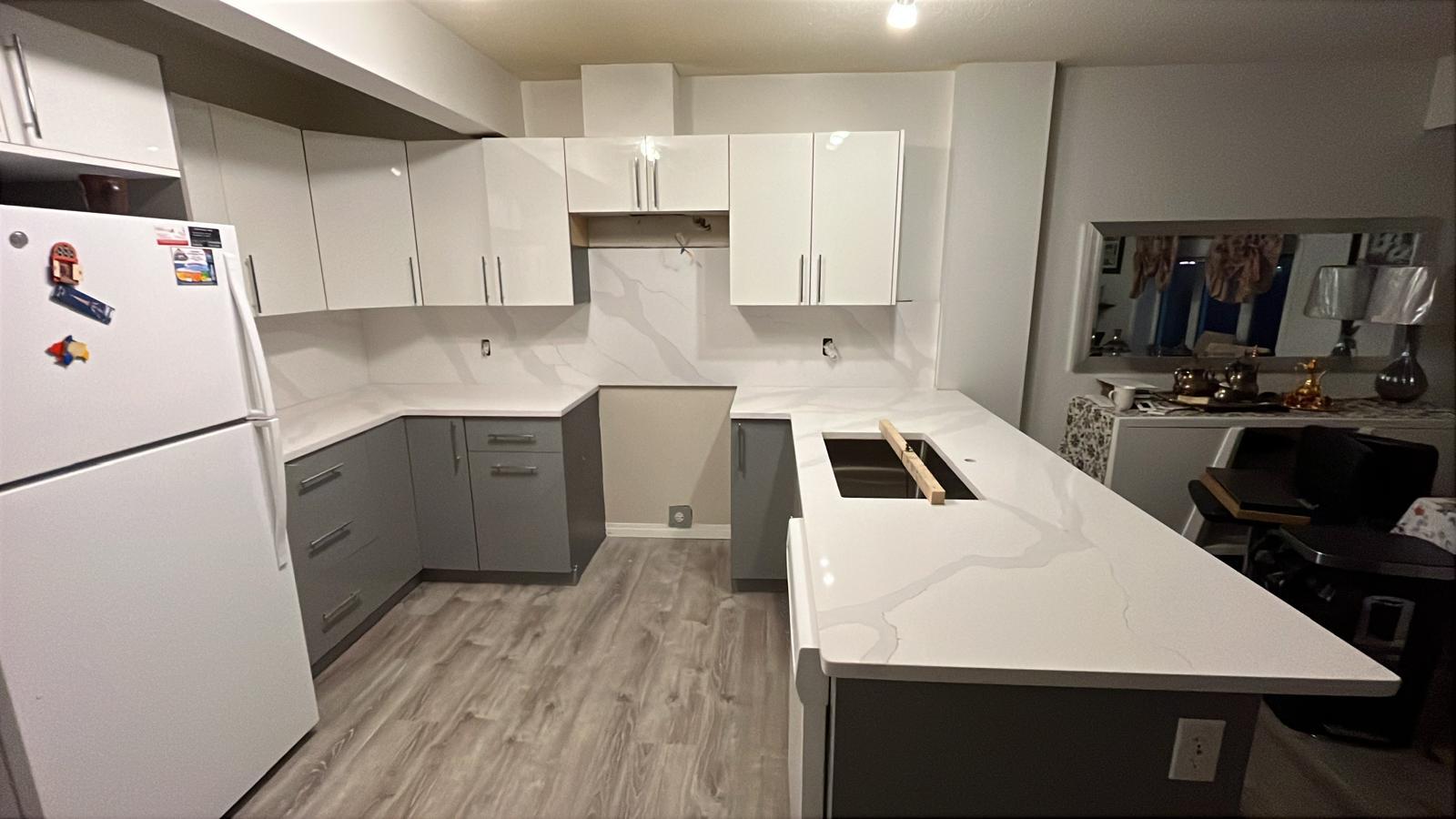 Angled view of a full-height white quartz backsplash