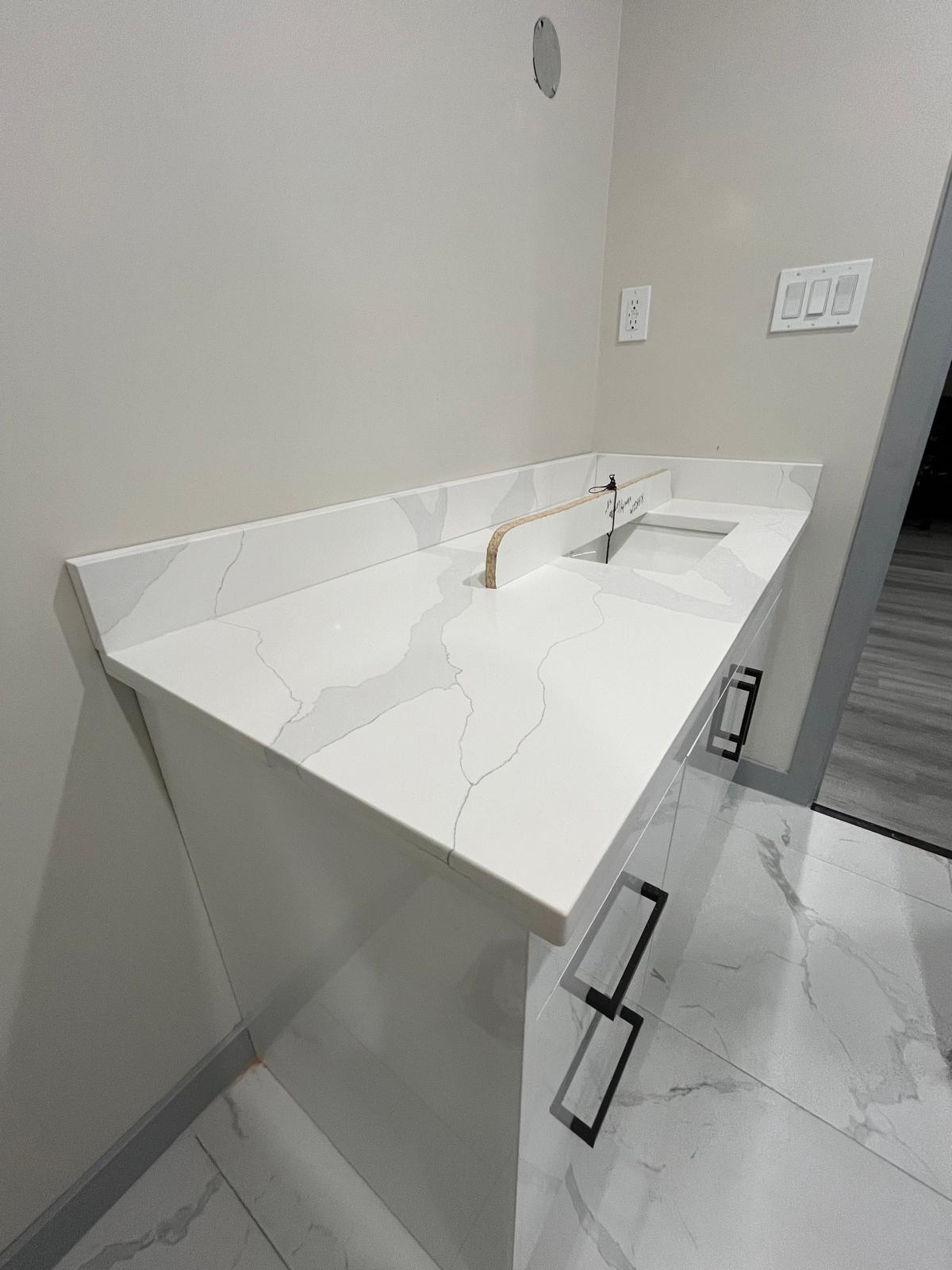 Laundry room countertop in white quartz with grey veining