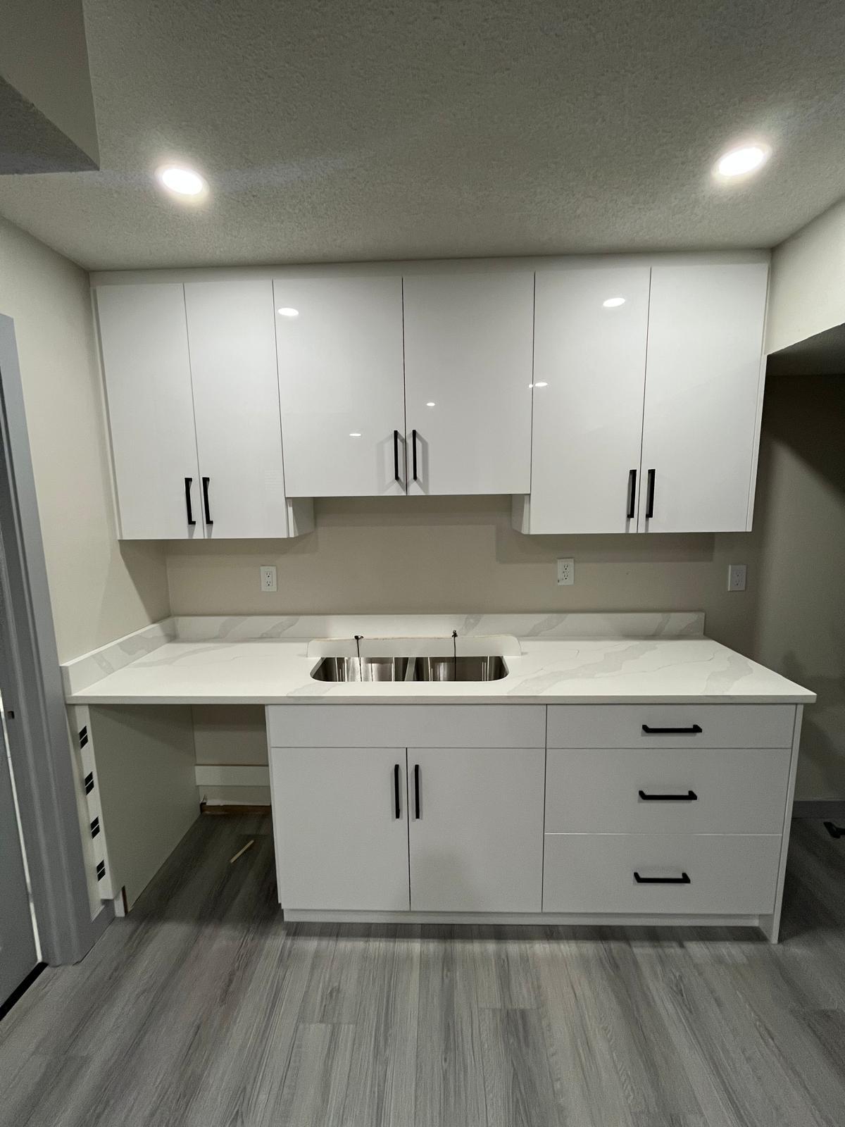 Angled view of a white quartz kitchen countertop with grey veining