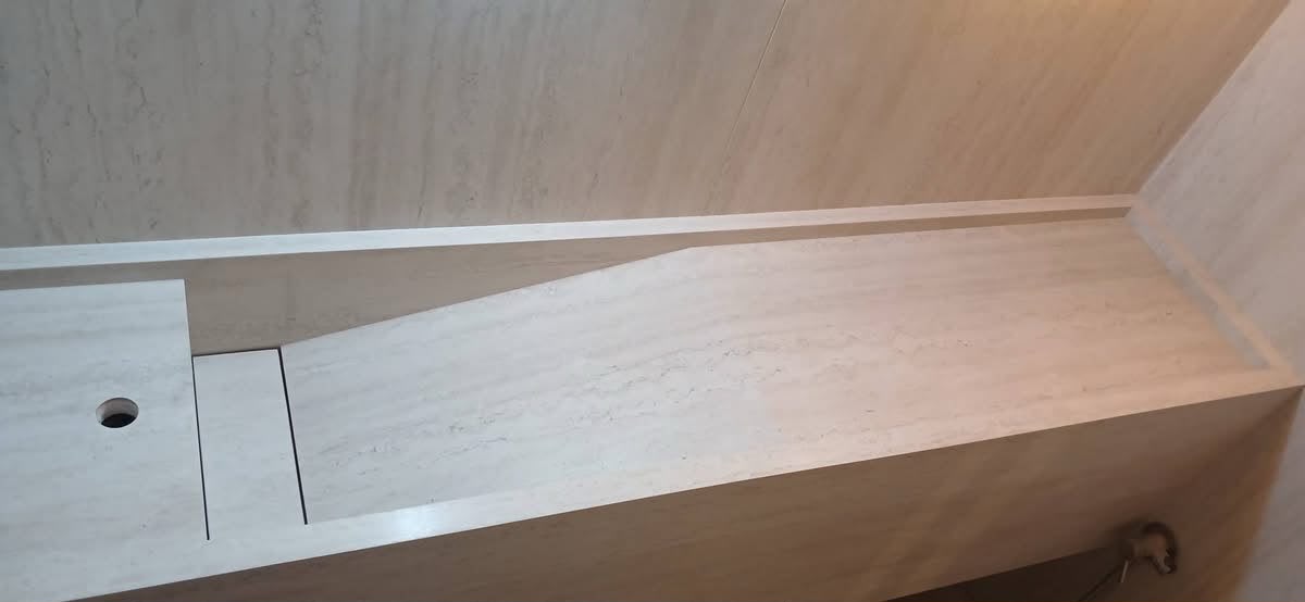 Custom stone vanity top with an integrated sink