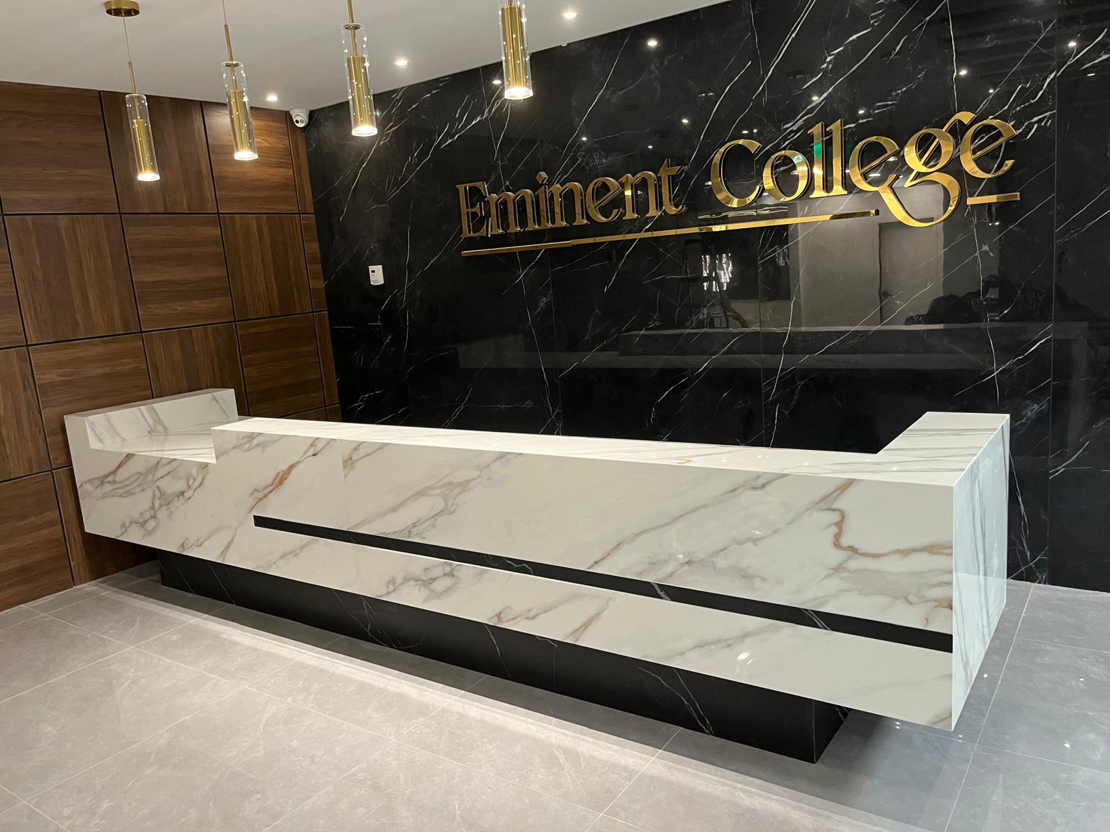 Angled view of a porcelain-clad commercial reception desk at Eminent College