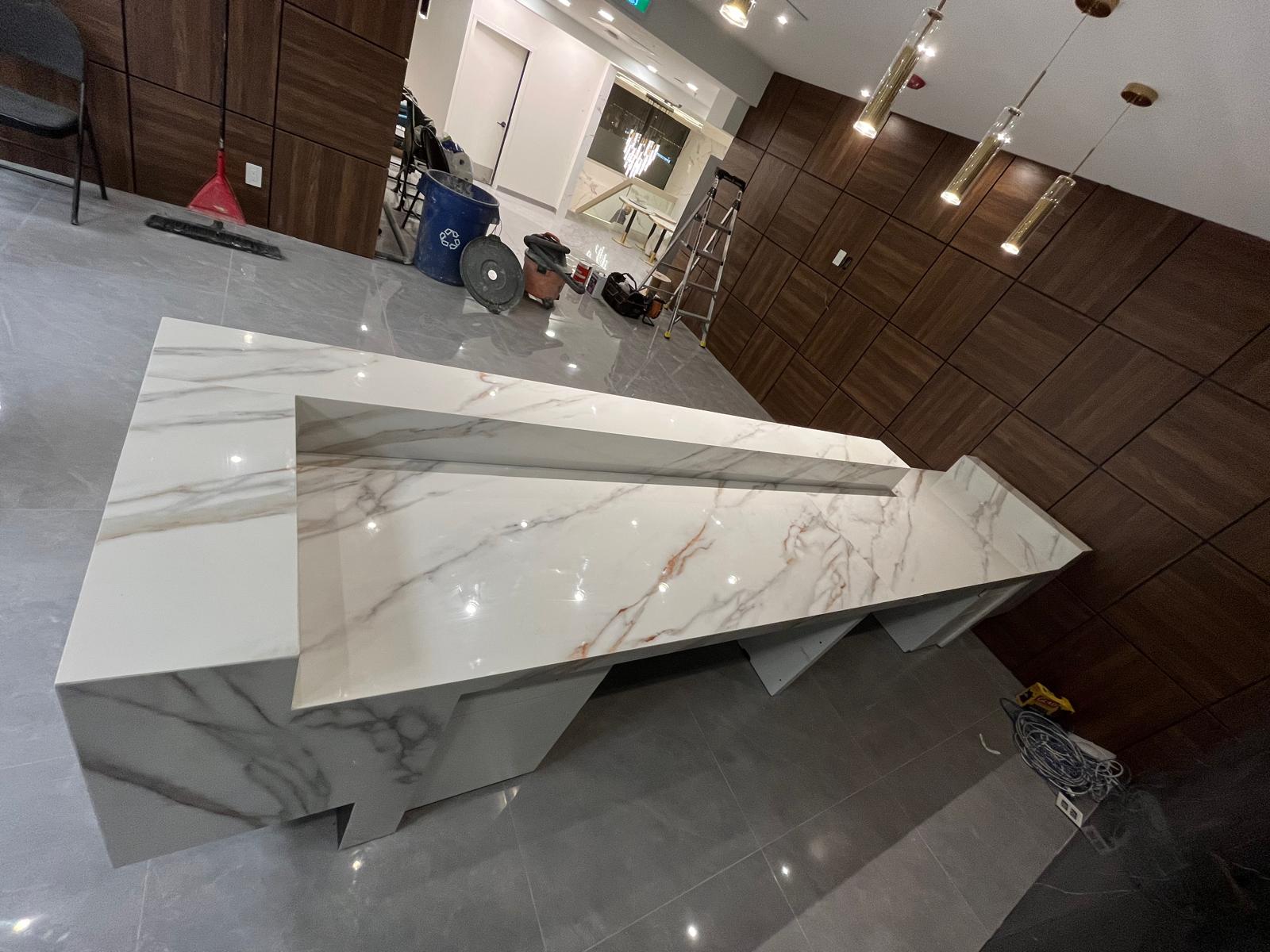 Entrance view of the Eminent College reception with a porcelain-clad front desk