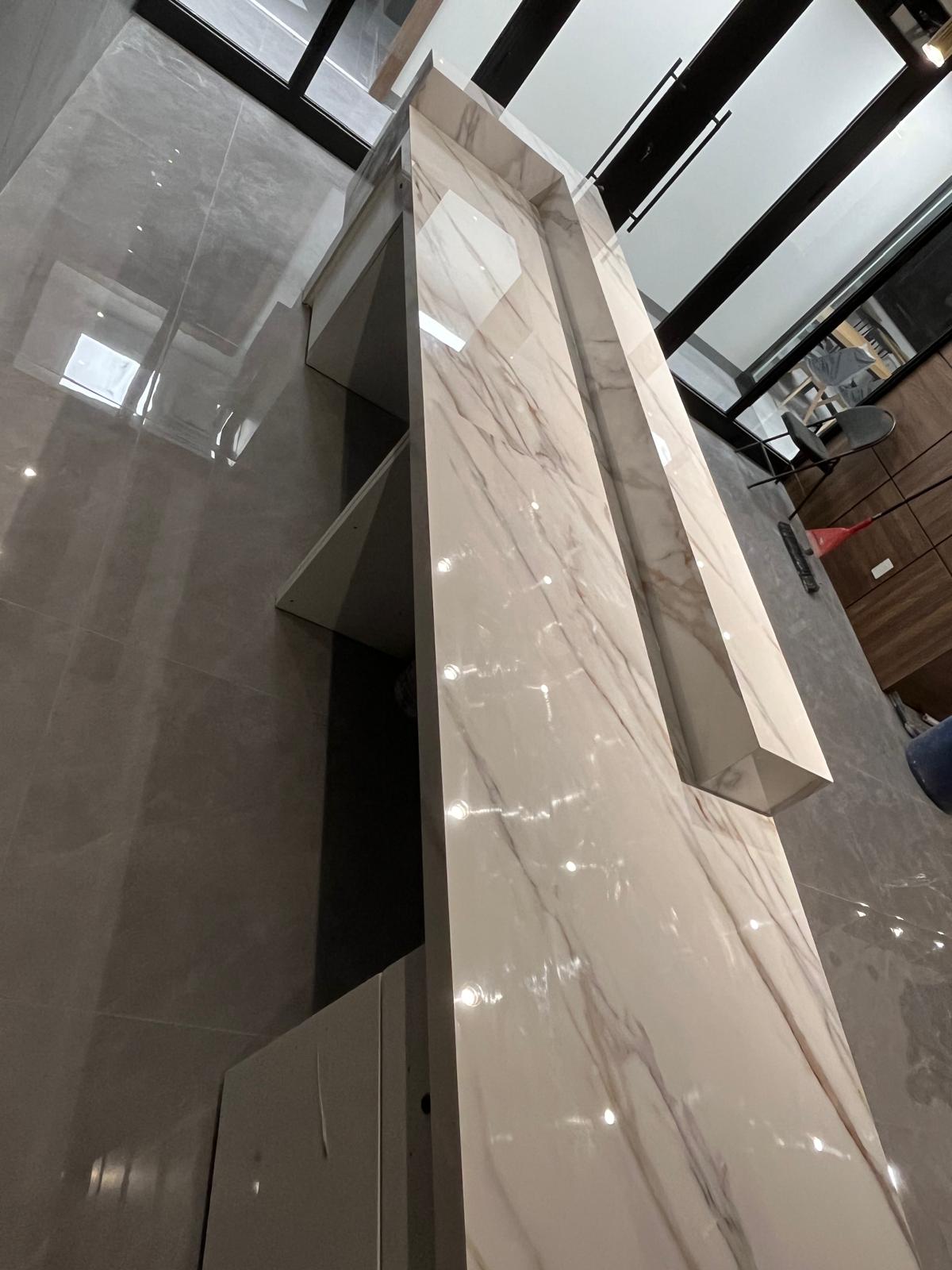 Rear view of a porcelain-clad commercial reception desk at Eminent College