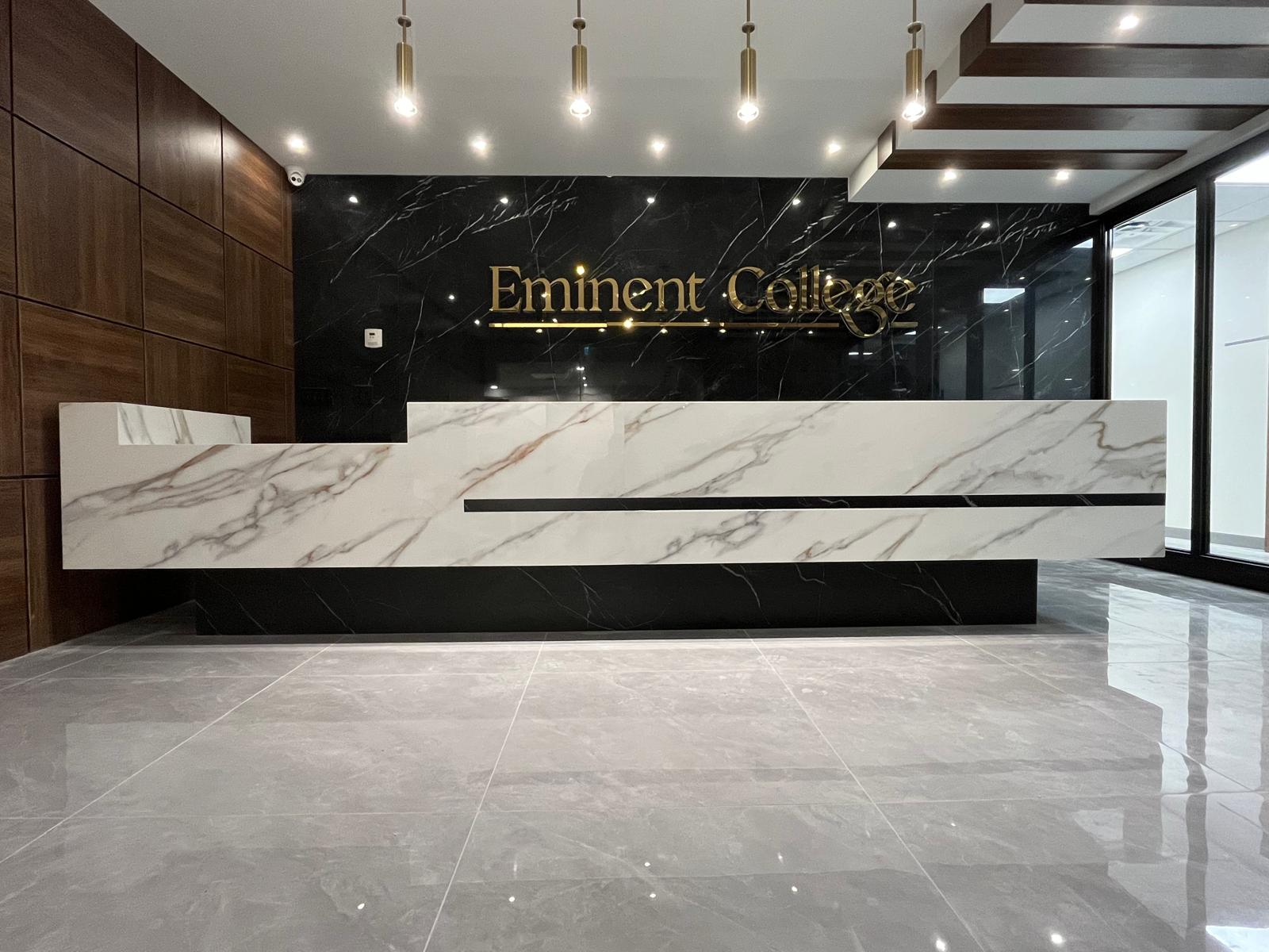Commercial reception desk clad in marble-look porcelain slab at Eminent College