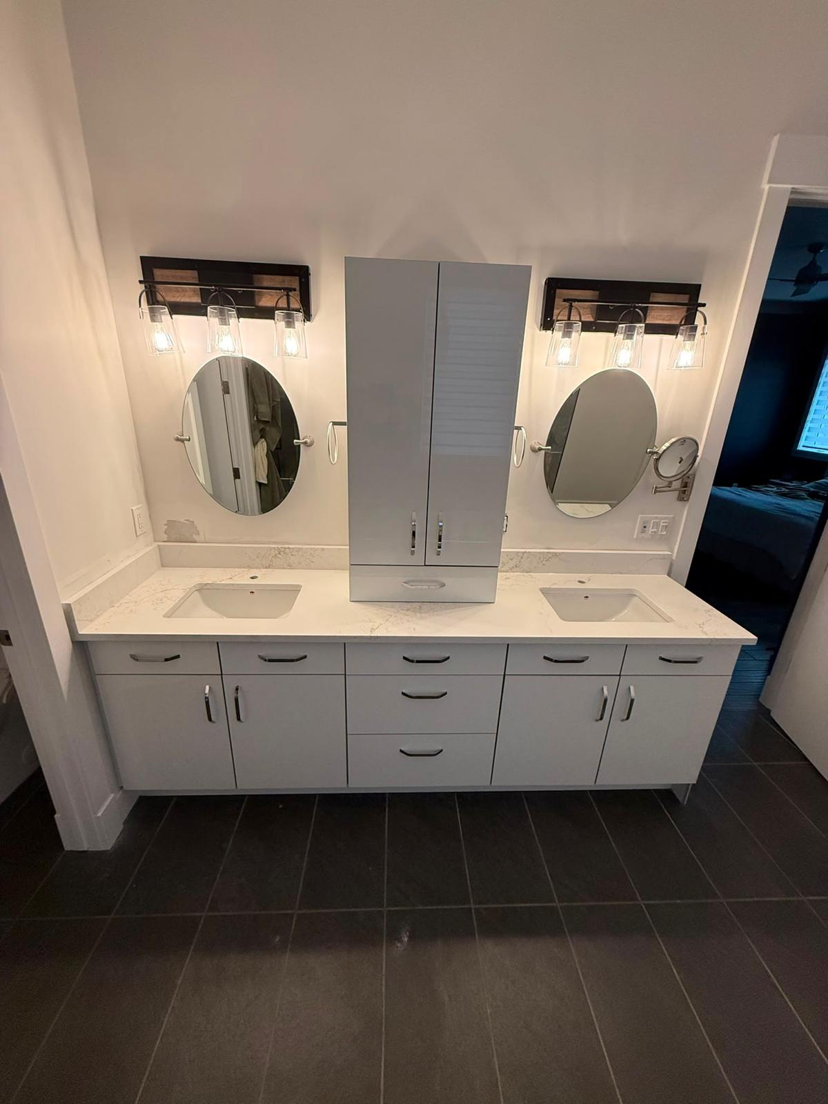 Bathroom double vanity with stone countertop and dual sinks
