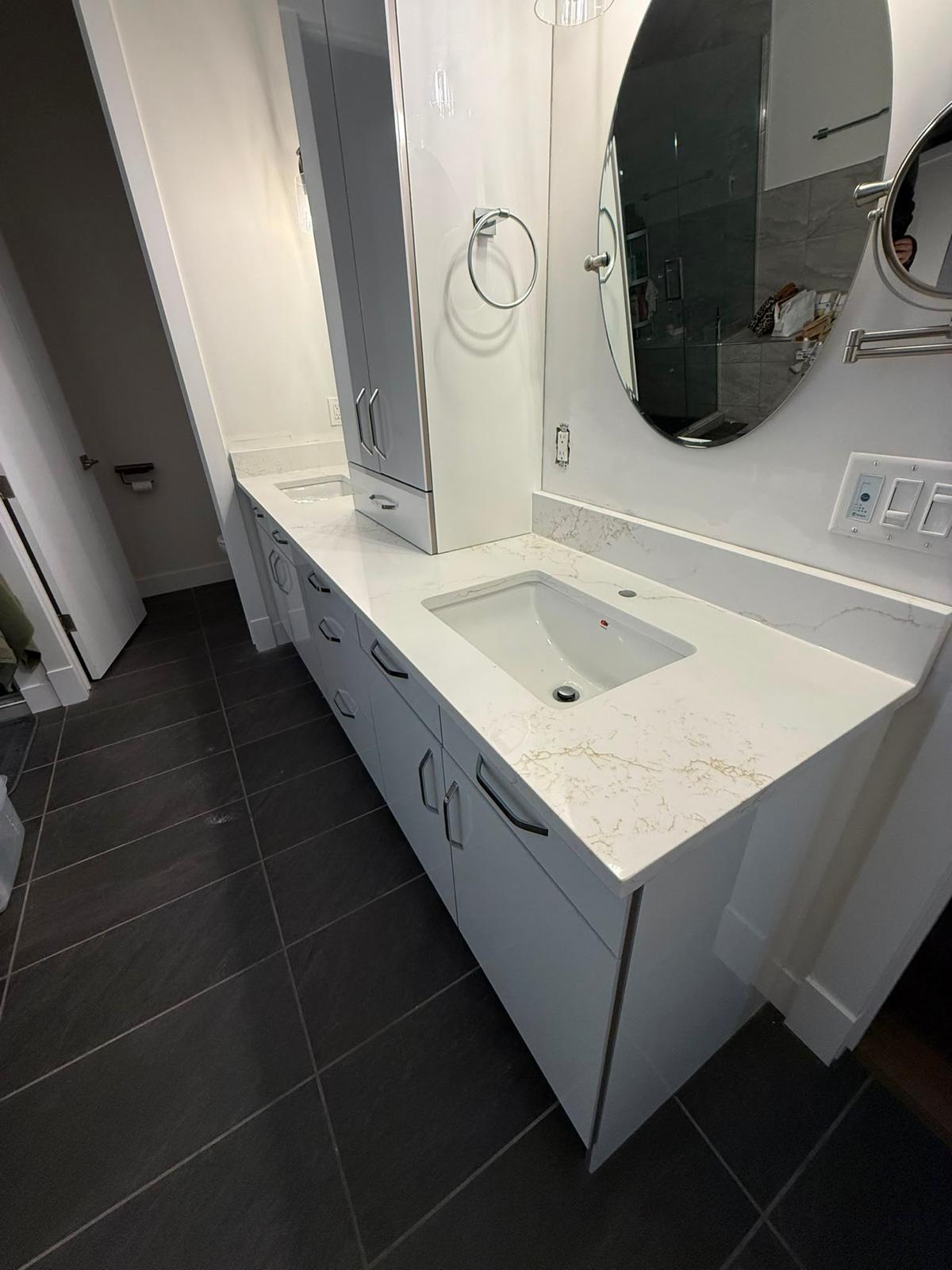Right side view of a bathroom double vanity with stone countertop