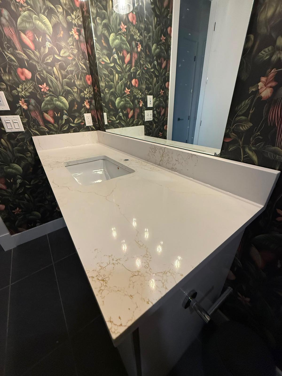 Close-up of a bathroom single vanity stone countertop and sink