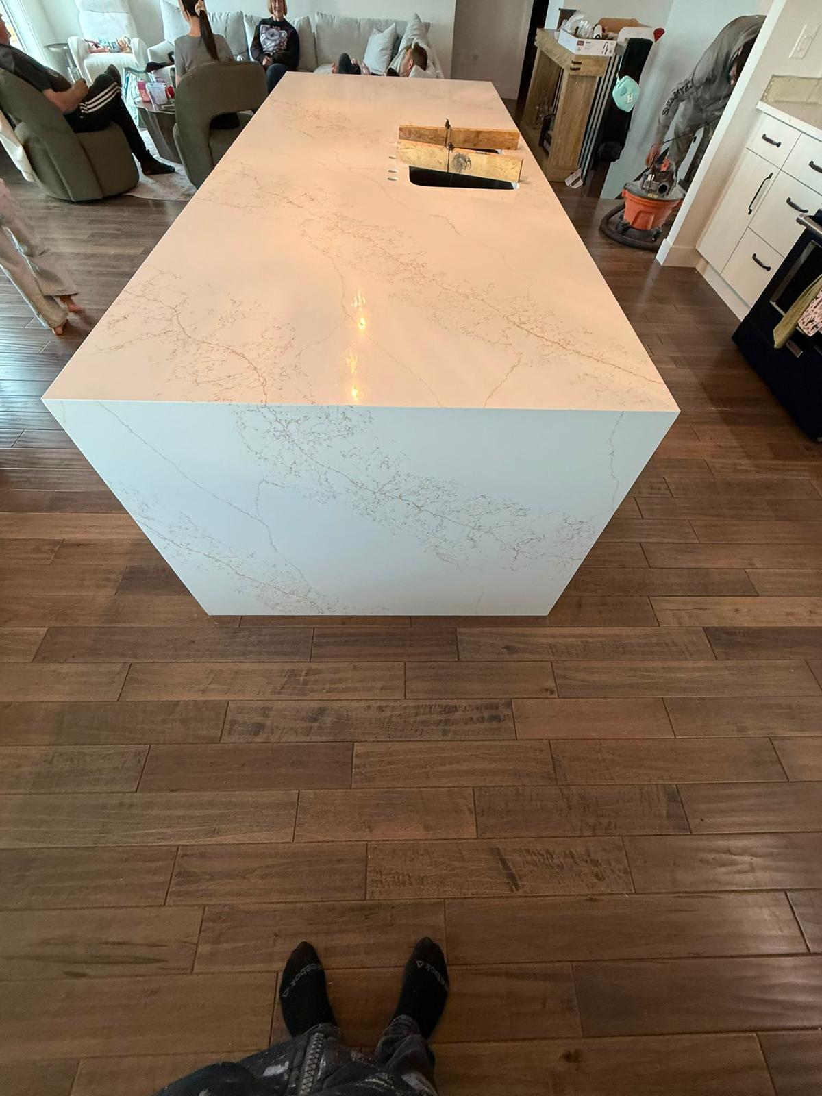 Right side view of a white quartz kitchen island