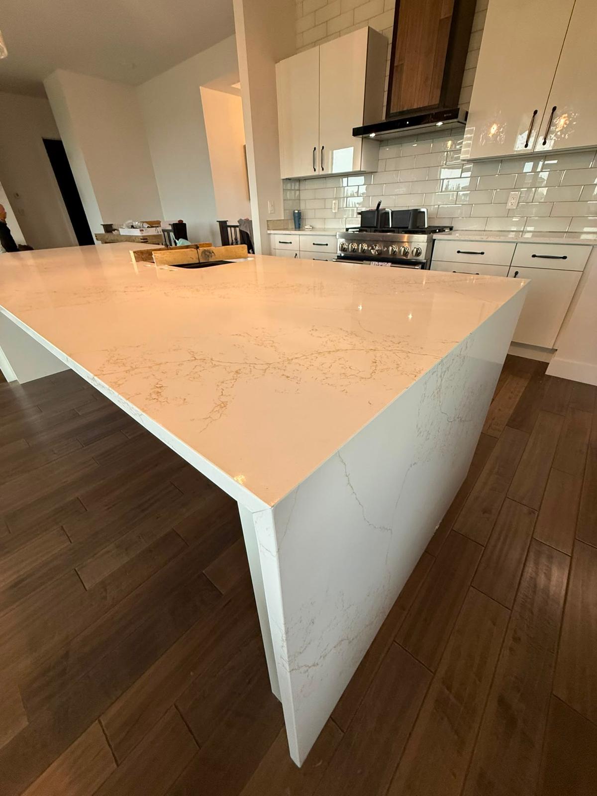 Right corner detail of a white quartz kitchen island