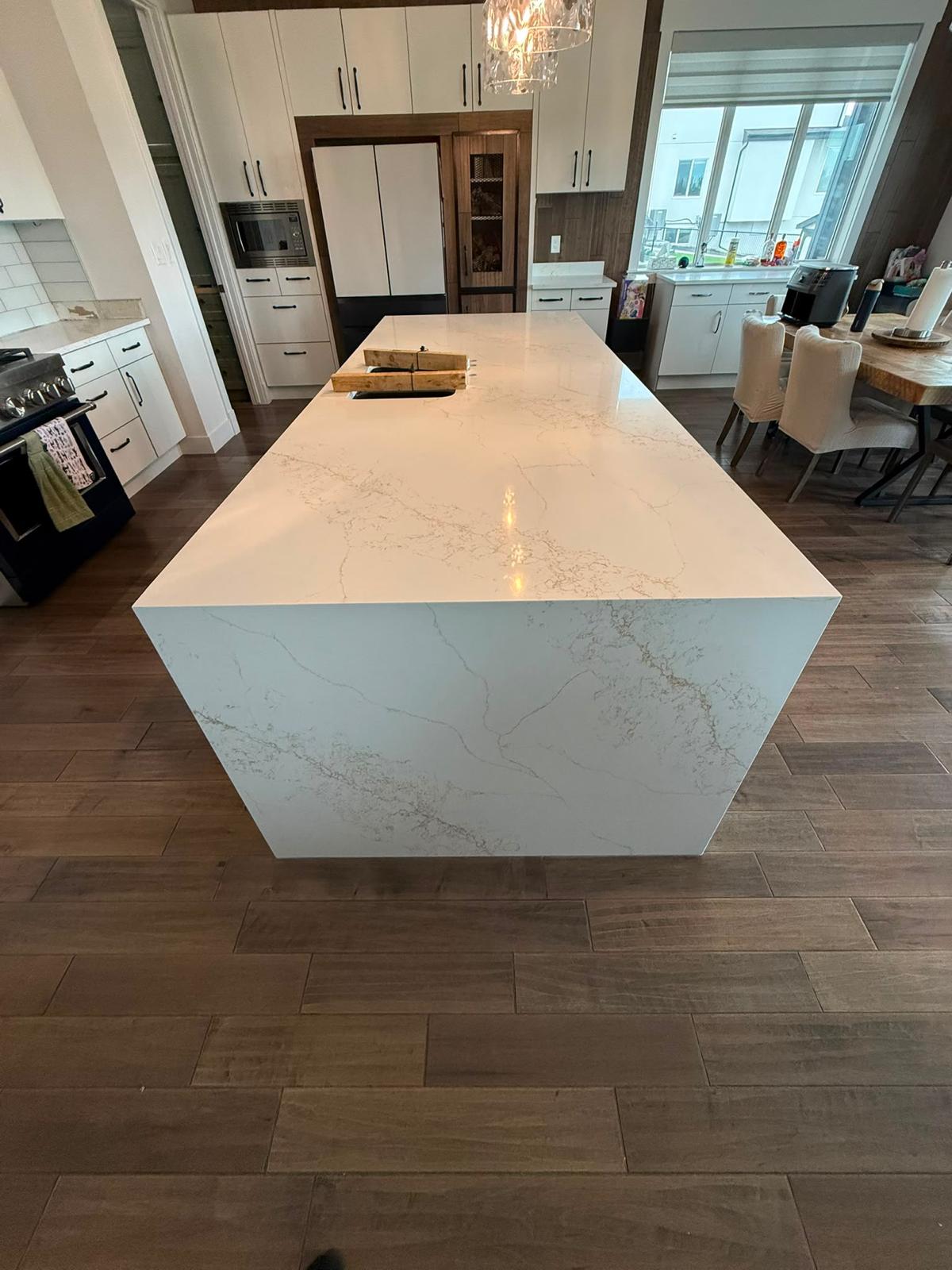 Left side view of a white quartz kitchen island