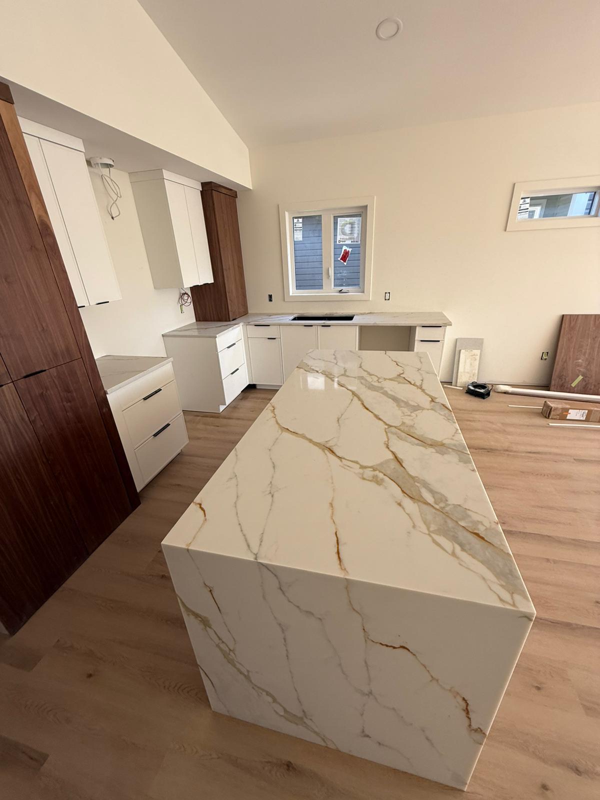 Kitchen with a stone island and matching countertops