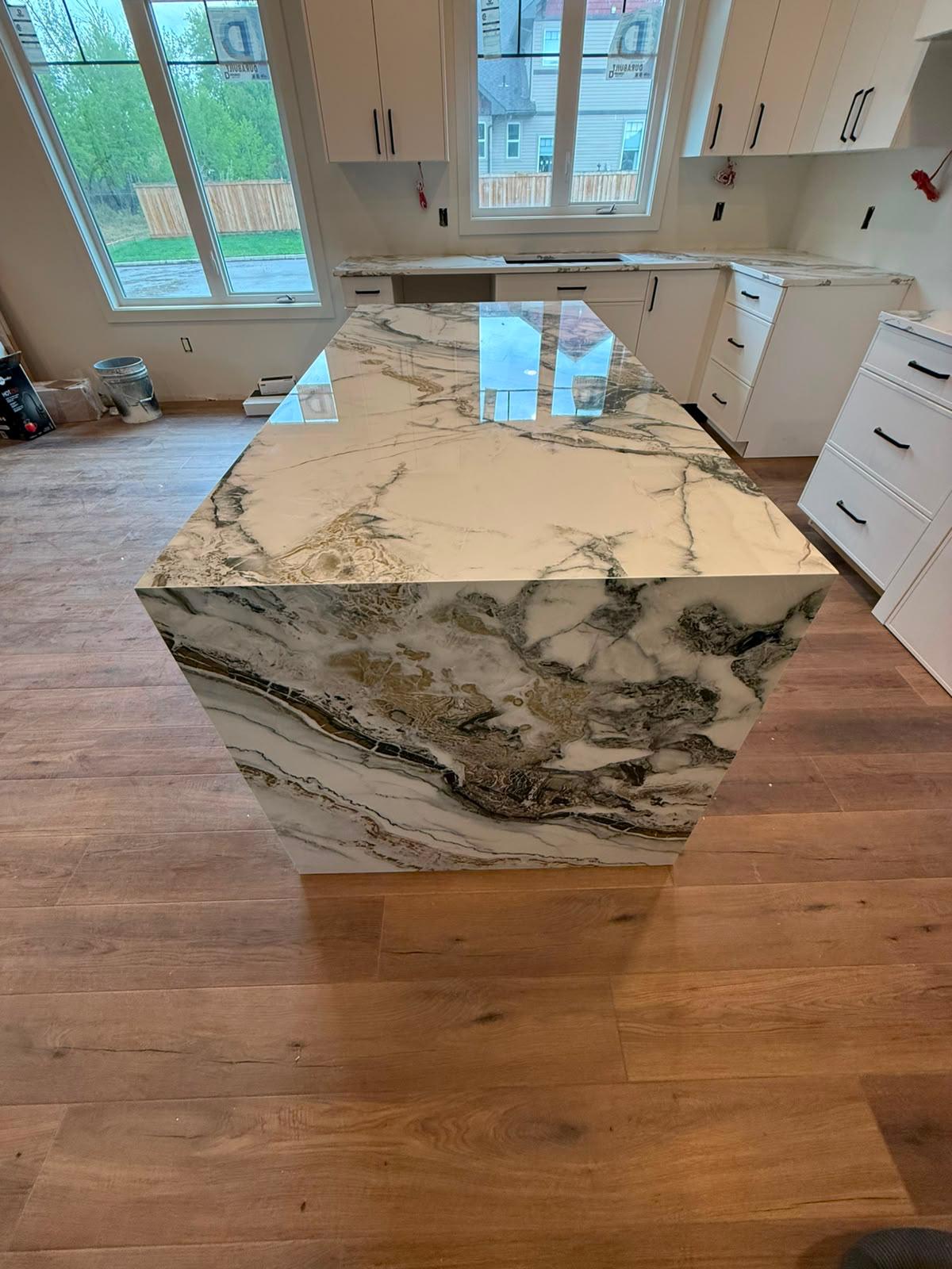 Side view of a black and white stone kitchen island