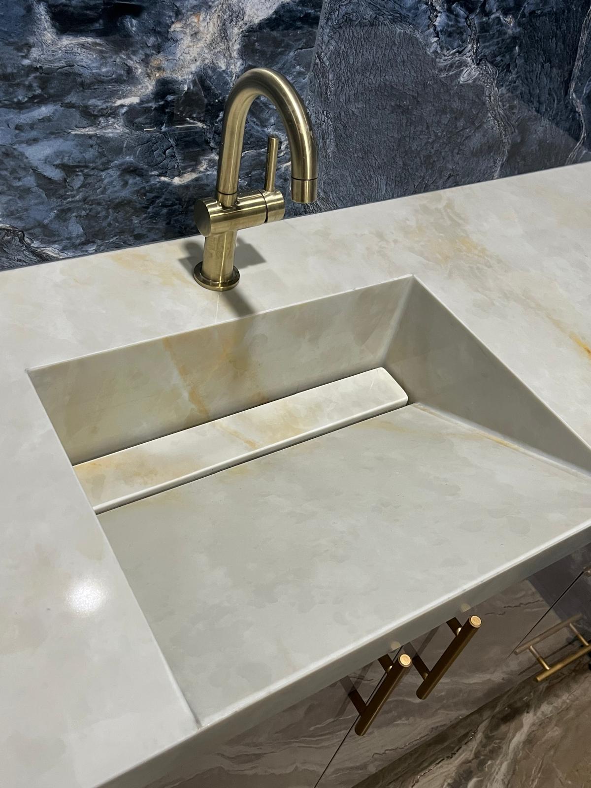 Left sink of a master bathroom stone vanity